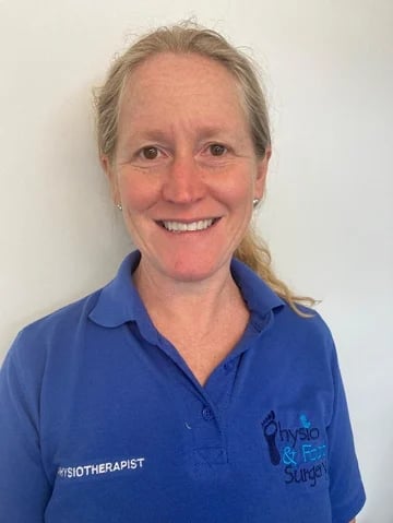Professional headshot of a smiling woman wearing a blue polo shirt with Biotherapist embroidered on it